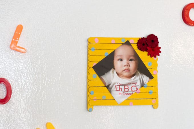 Popsicle Stick Photo Frame on white wall.