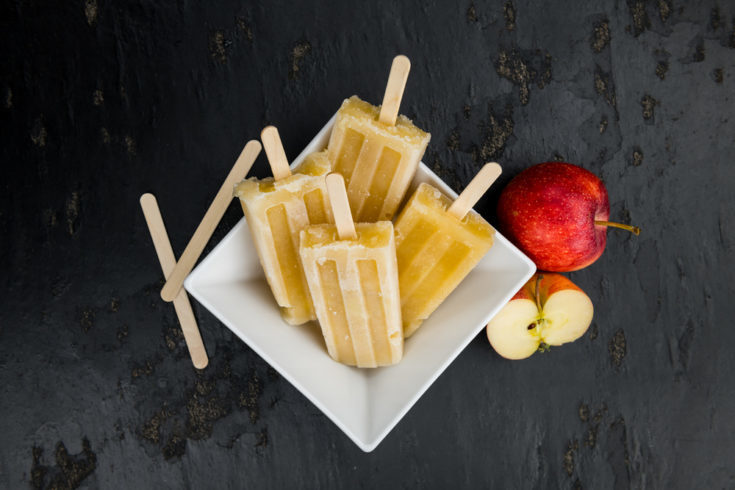 Portion of homemade Apple Popsicles (selective focus; close-up shot) on a vintage background