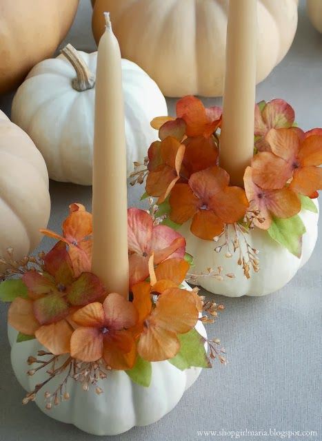 White pumpkin candle holder with cream candle and orange floral table centerpiece