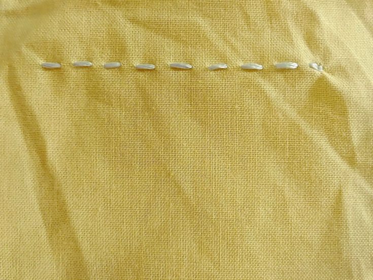 running stitch embroidery example in a yellow cloth