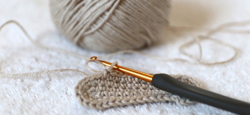 selective focus of crochet yarn and a hook