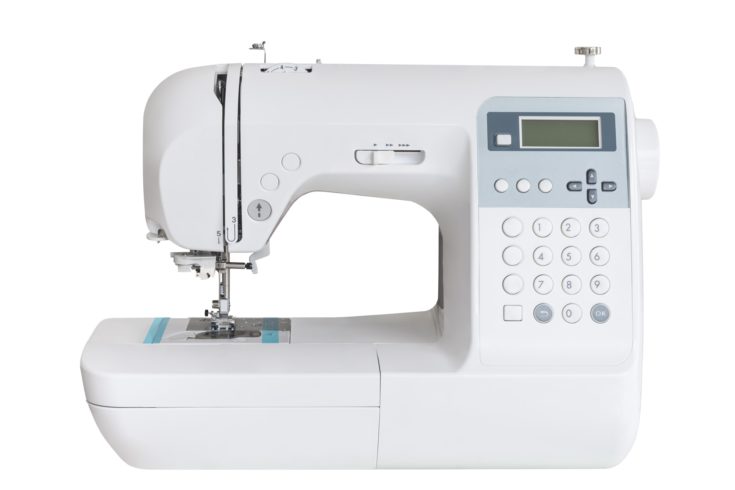 Sewing machine with a lot of buttons isolated on a white background