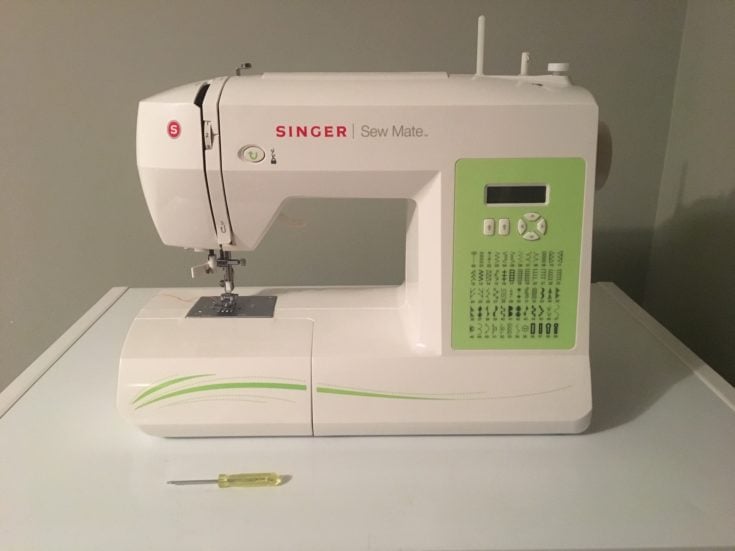 Singer Sewing Machine with screw on the table