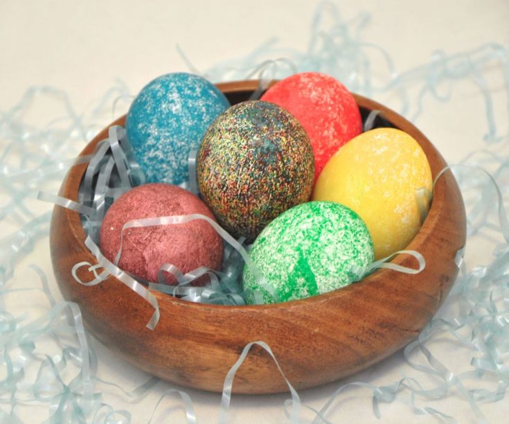 Dyed Easter Eggs With Rice in a wooden bowl
