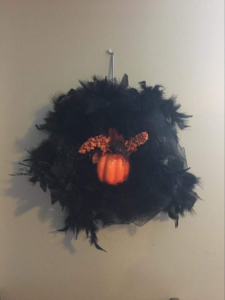 a custom made Spooky Door Wreath hanged on the wall