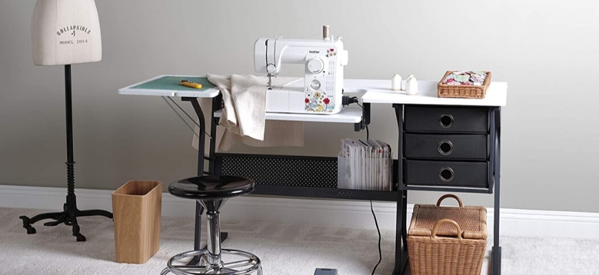 Sewing machine on a stylish portable sewing table with chair and sewing materials.