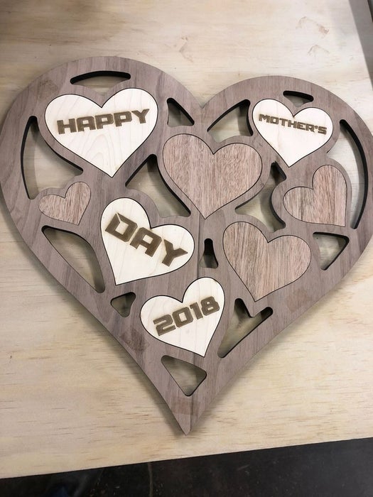 Personalized heart-shaped wooden art piece with a message.