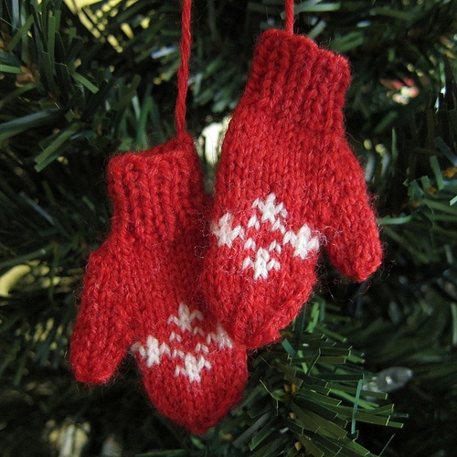 Red mitten ornament hanging on Christmas tree