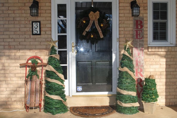Tomate cages Christmas trees with gold ribbon and star in the front door