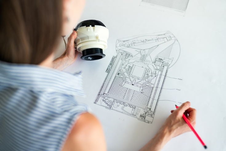 woman drawing a blueprint