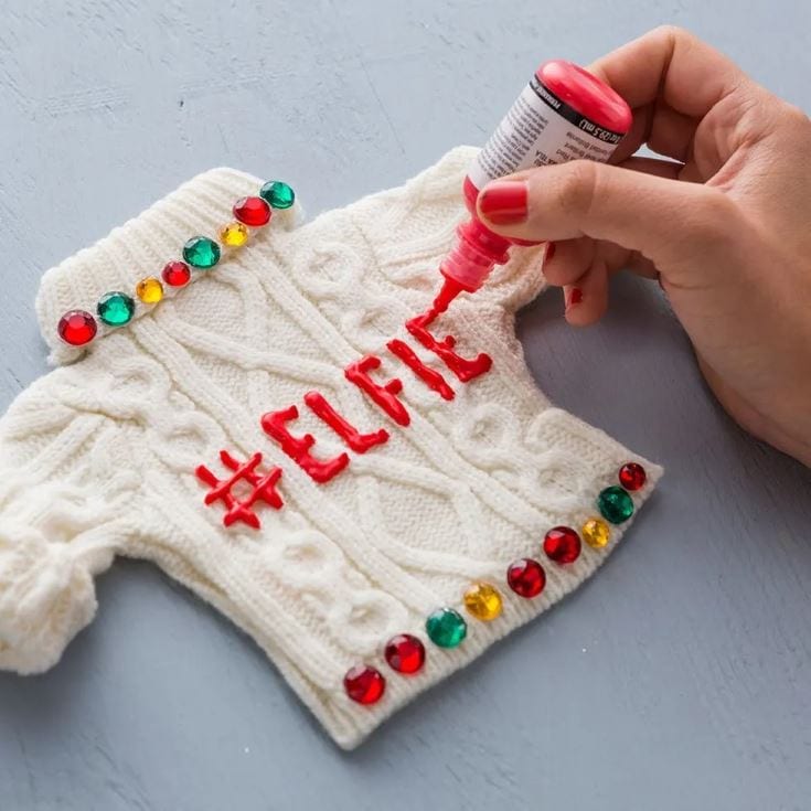 woman's hand decorating ugly sweater
