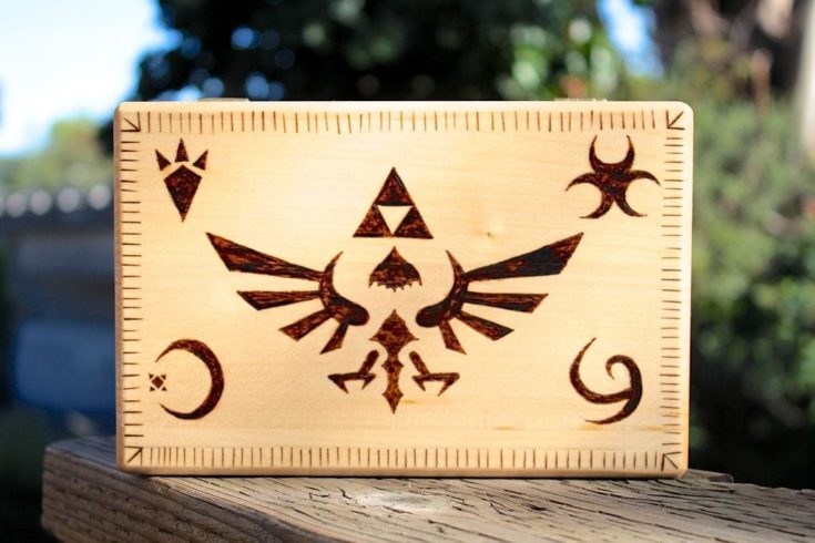 a wooden box with legend of selda wood burn design