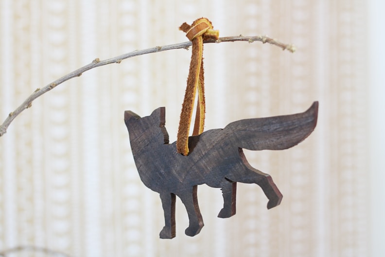 Wooden Fox Tied to a Twig Using a Brown Leather