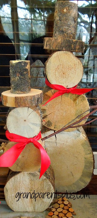DIY Woodpile Snowman tied with red bows