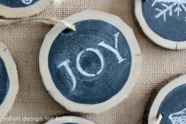 Blue circle woodslice with joy text ornaments with satori design for living written on foreground