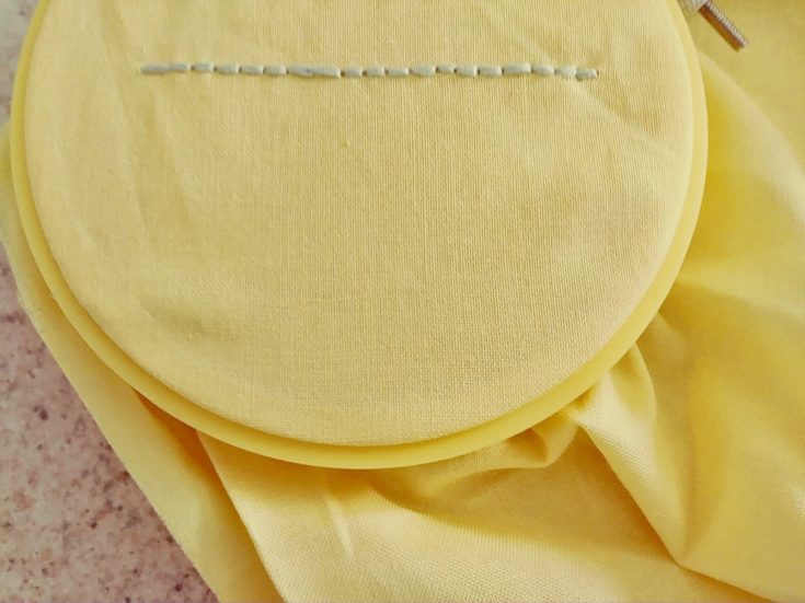 back stitch embroidery example in a yellow cloth
