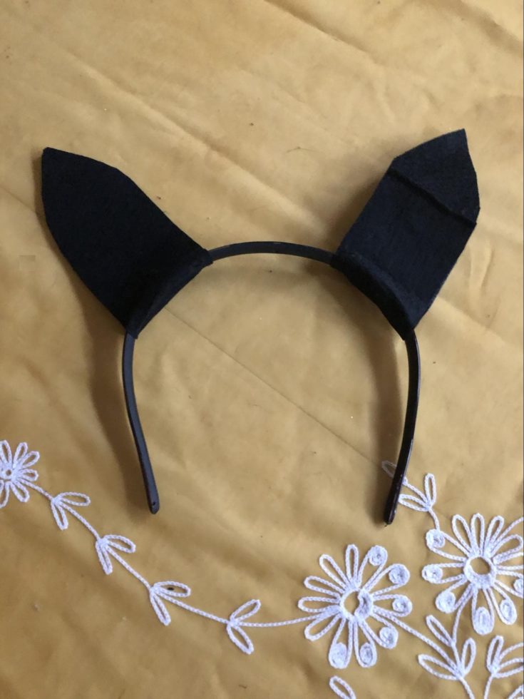 a black headband with bat ears on it