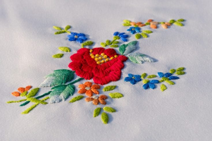 Embroidered flower on white cloth.