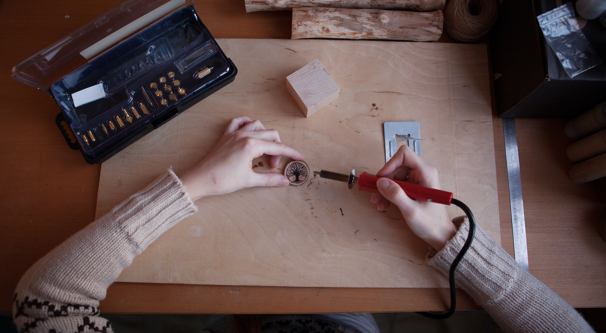 Woman doing wood burning on the table