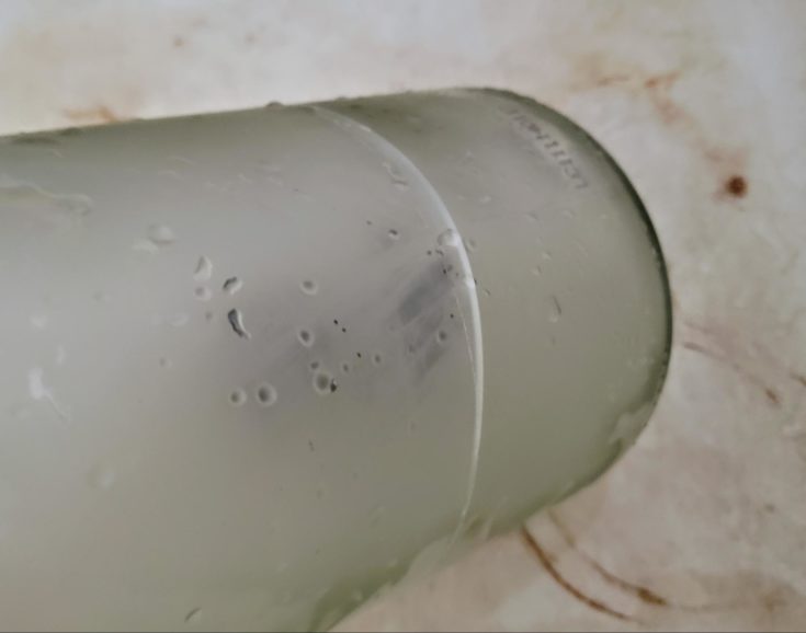 Part of the bottle that has a line submerged to cold water.