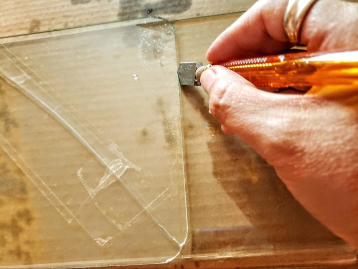 Score with a consistent pressure while cutting the glass with glass cutter.