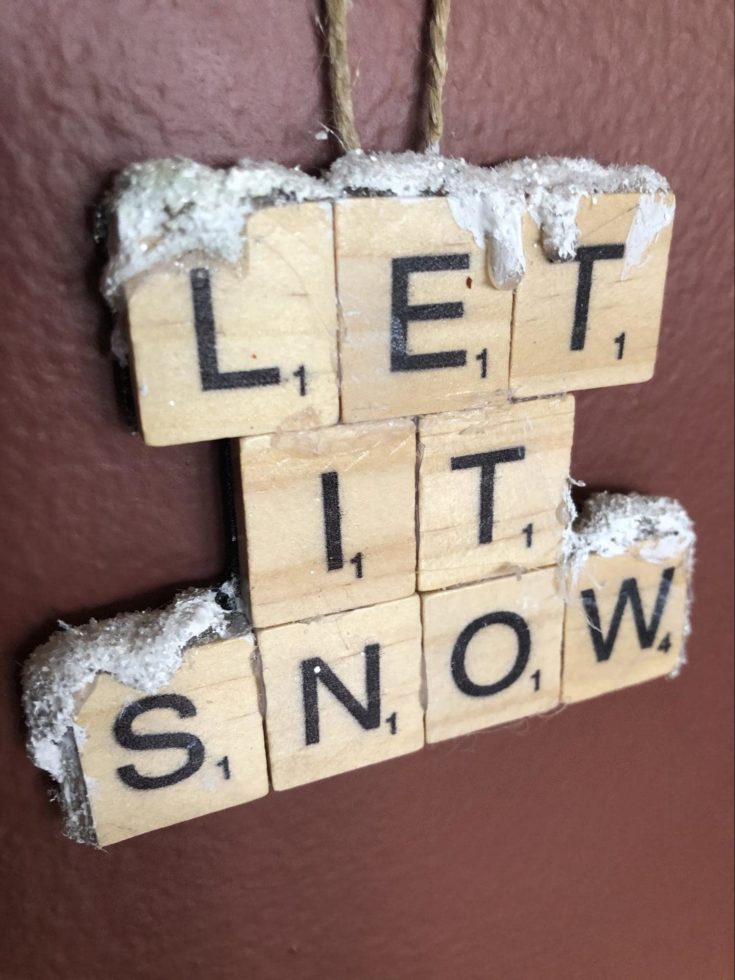 LET IT SNOW ornaments on a brown background.