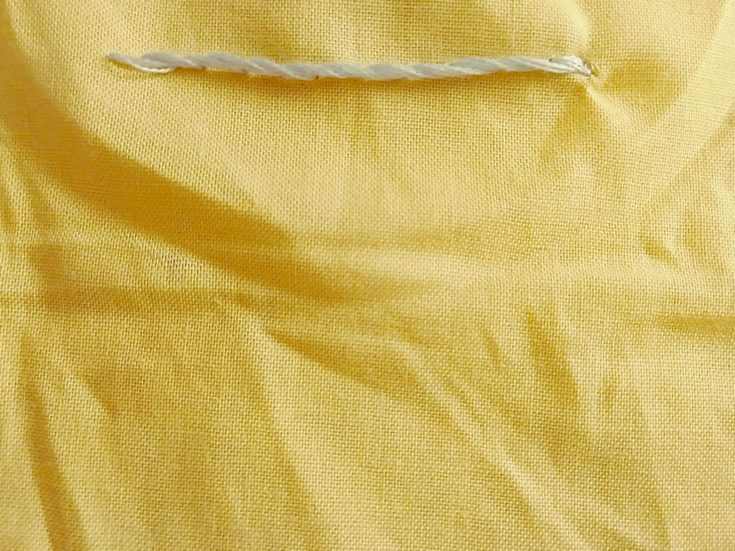stem stitch embroidery example in a yellow cloth